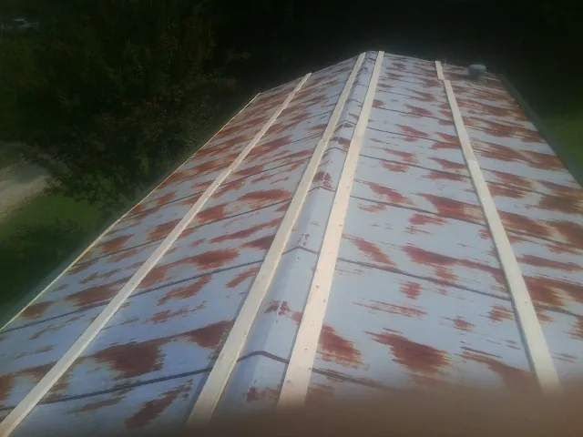 Rusted metal roof panels with new wood purlins before replacement — Storm Damage Roof Repair in Port Monmouth by Roofing Brothers