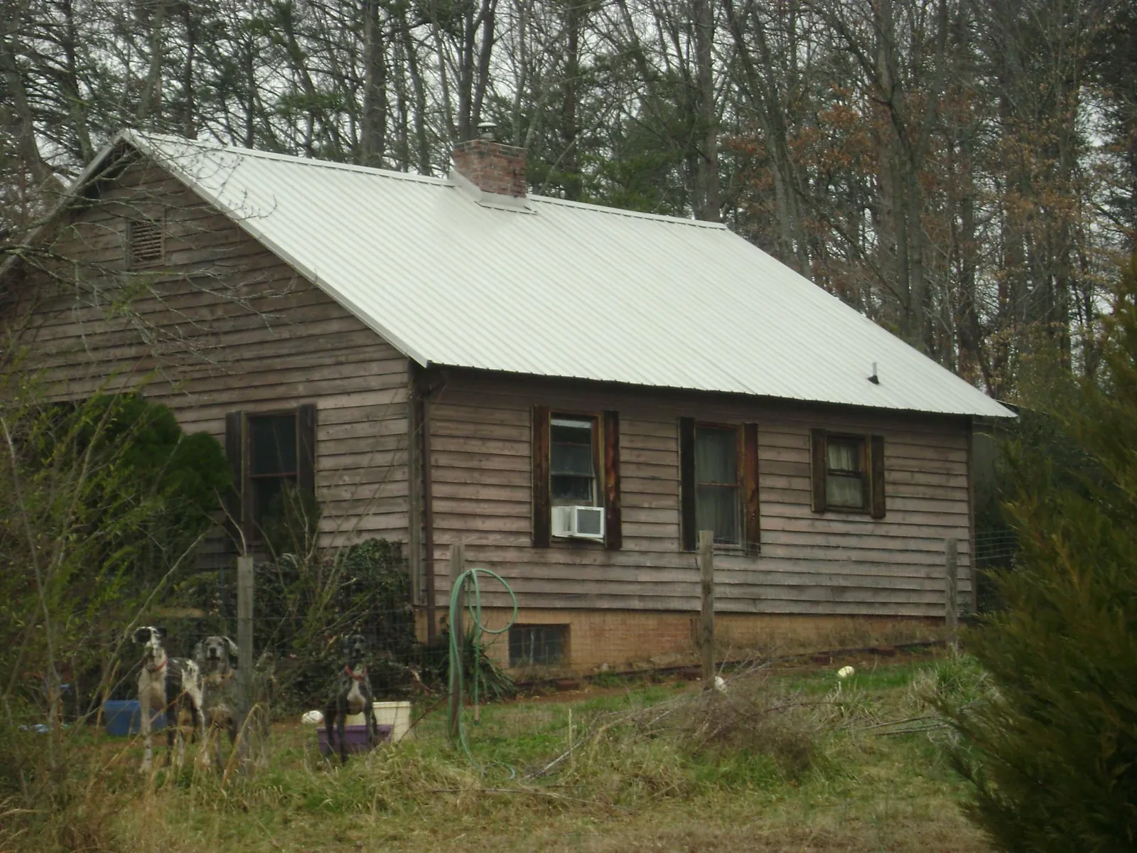 White metal roof on an old wood sided farmhouse, from a Metal Roof Installation job in Port Monmouth